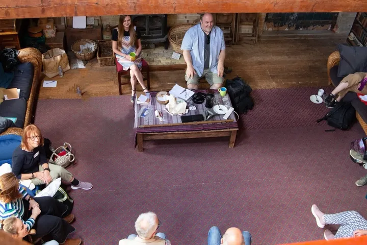 A relaxed teaching session in a rustic timber-beamed hall