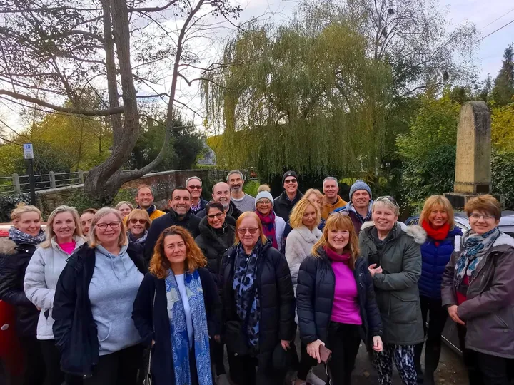 A large retreat group gathered by the bridge in Shoreham village